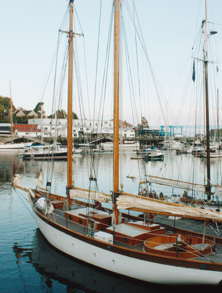 white sailboat with brown masts